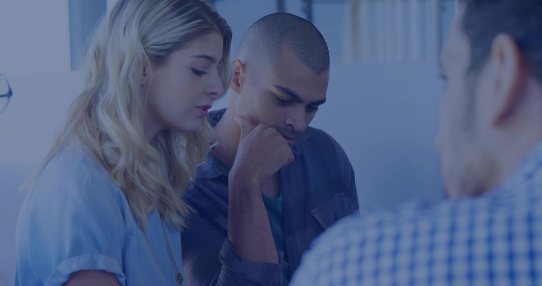 Leaning coworkers focusing on project in modern office meeting for teamwork collaboration