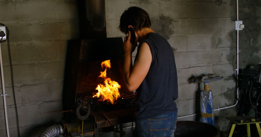 Person Using Forge Welder in Workshop - Free Images, Stock Photos and Pictures on Pikwizard.com