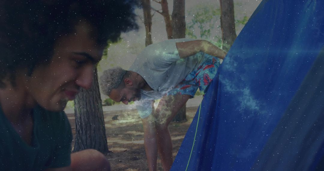 Friends Setting Up Tent in Forest during Astronomical Phenomena