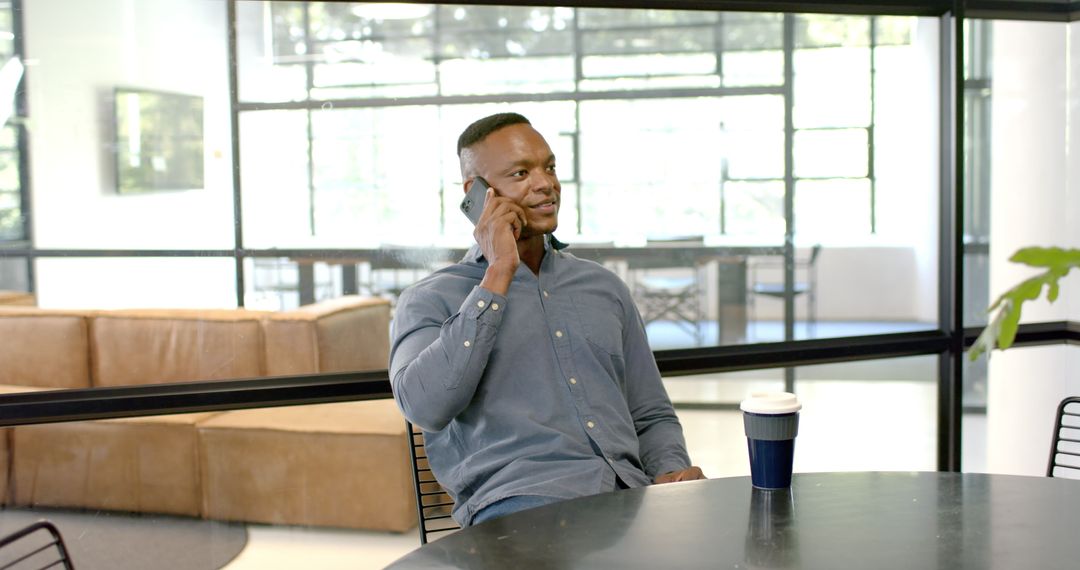 Professional Chat: Man Discussing Business on Phone in Modern Office