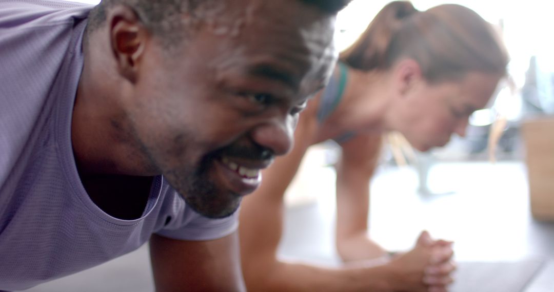 Diverse Couple Holding Plank Position in Home Workout Routine