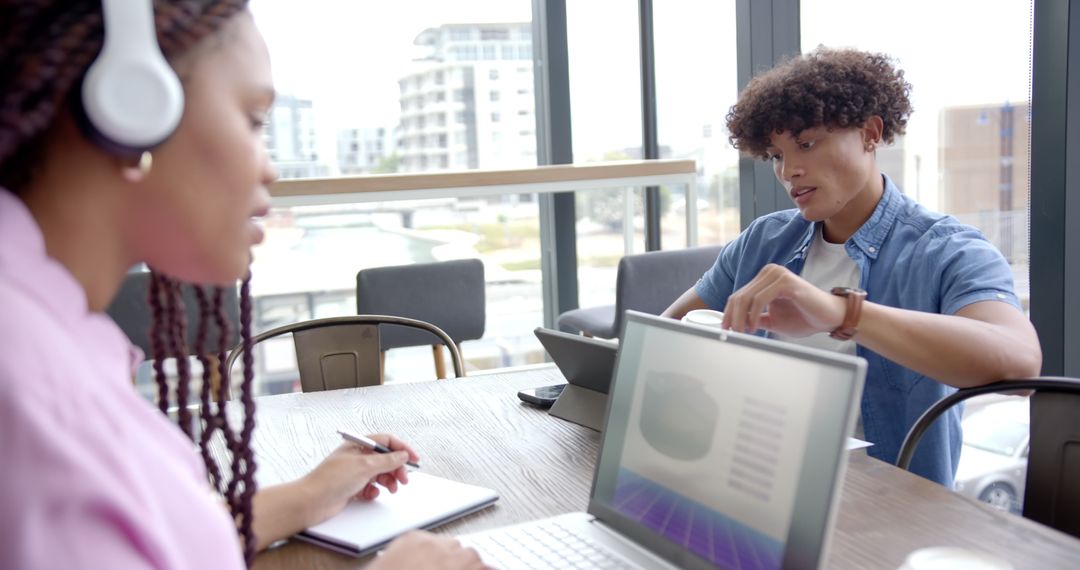 Colleagues Collaborating on Laptop during Business Meeting