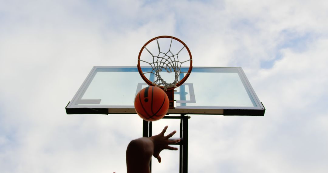 Youth Shooting Basketball Towards Hoop, Blue Sky Background - Free Images, Stock Photos and Pictures on Pikwizard.com