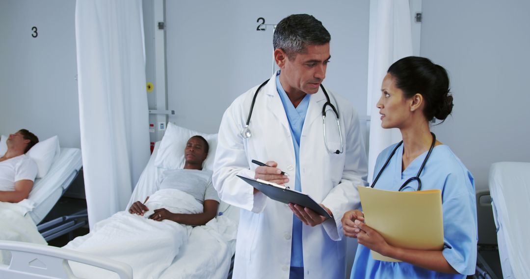 Doctors Discussing Patient Care Plans in Hospital Ward - Free Images, Stock Photos and Pictures on Pikwizard.com