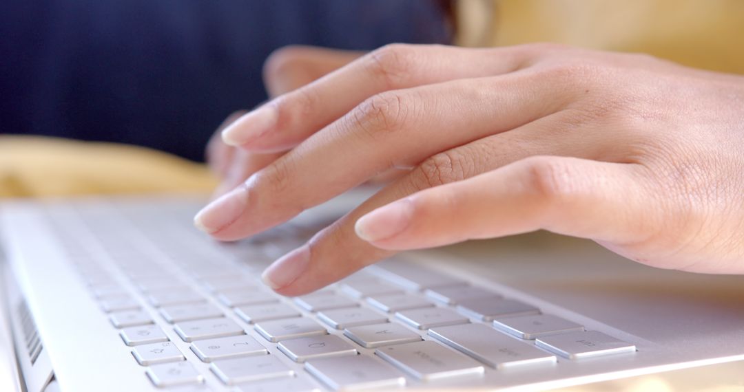 Close-Up of Hands Typing on Laptop Keyboard for Productivity Theme