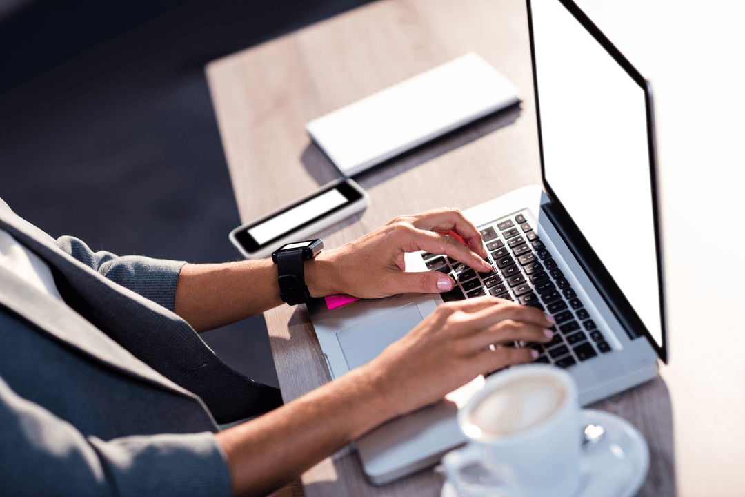 Close-Up Hands on Laptop at Desk with Modern Workspace Setup