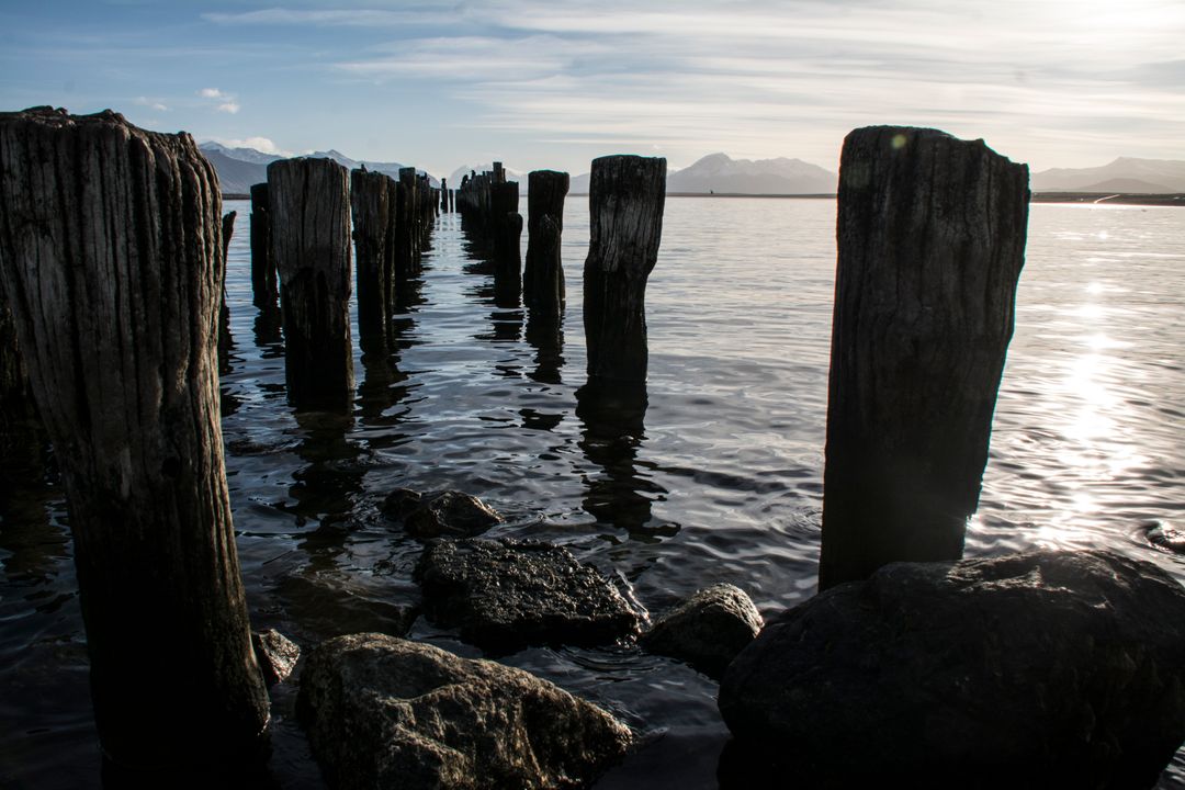 Old Wooden Piers in Calm Ocean Water at Sunset - Free Images, Stock Photos and Pictures on Pikwizard.com