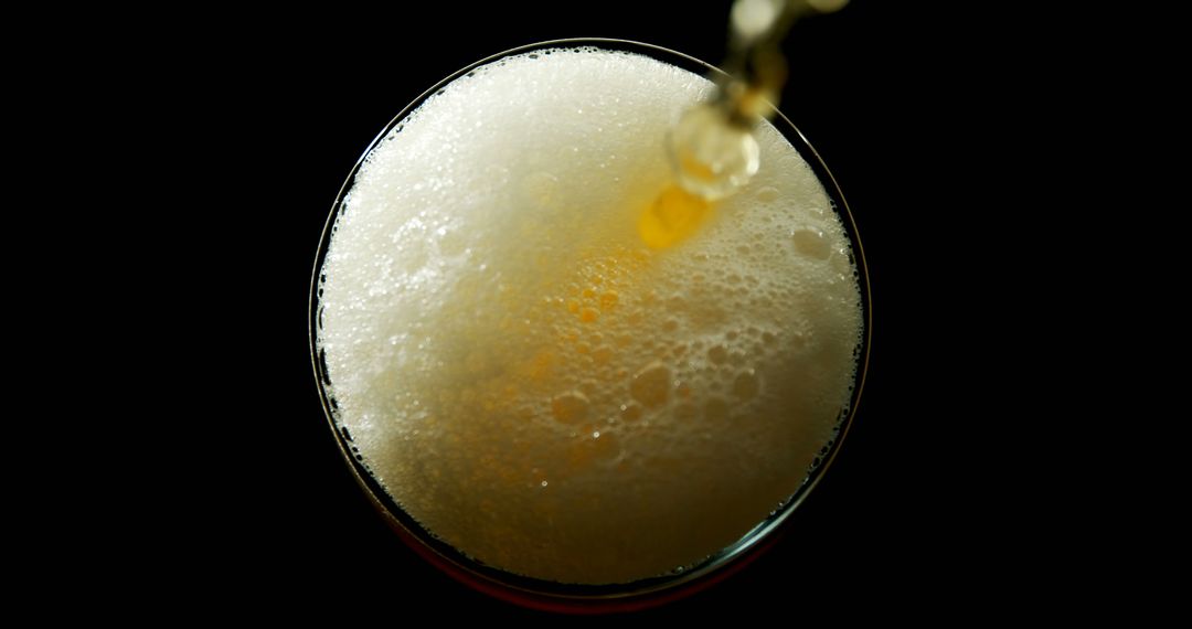 Close-Up of Beer Being Poured into Glass with Bubbling Foam - Free Images, Stock Photos and Pictures on Pikwizard.com