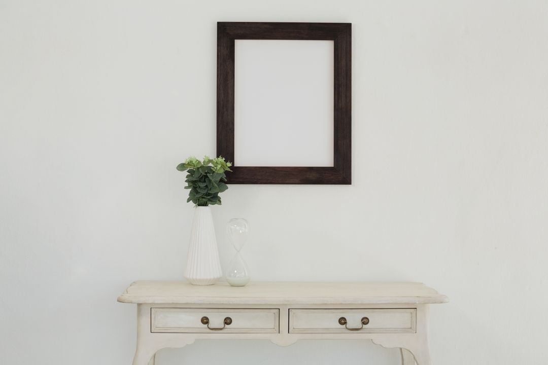 Wooden frame and vase against white wall - Free Images, Stock Photos and Pictures on Pikwizard.com