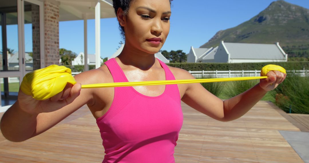 Focused Woman Exercising with Resistance Band Outdoors - Free Images, Stock Photos and Pictures on Pikwizard.com