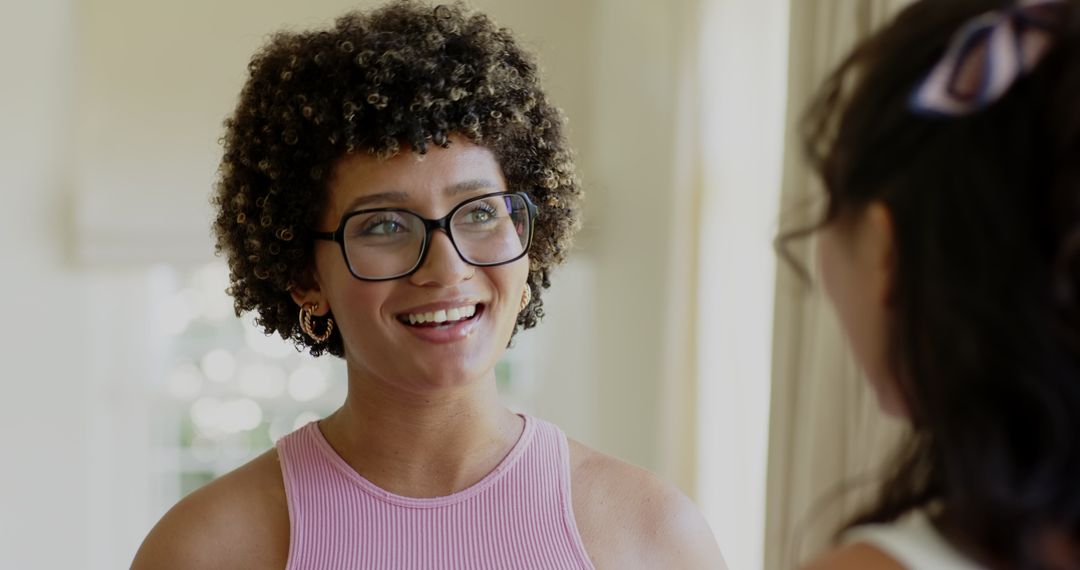 Smiling Woman with Glasses Engaging in Friendly Home Conversation