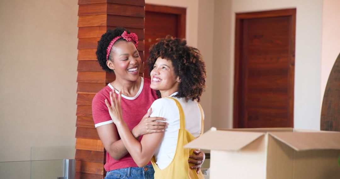 Joyful Lesbian Couple Embracing in New Home Together