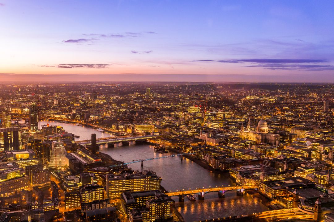 Aerial View of London Cityscape at Sunset with River Thames and Illuminated Skyline - Free Images, Stock Photos and Pictures on Pikwizard.com