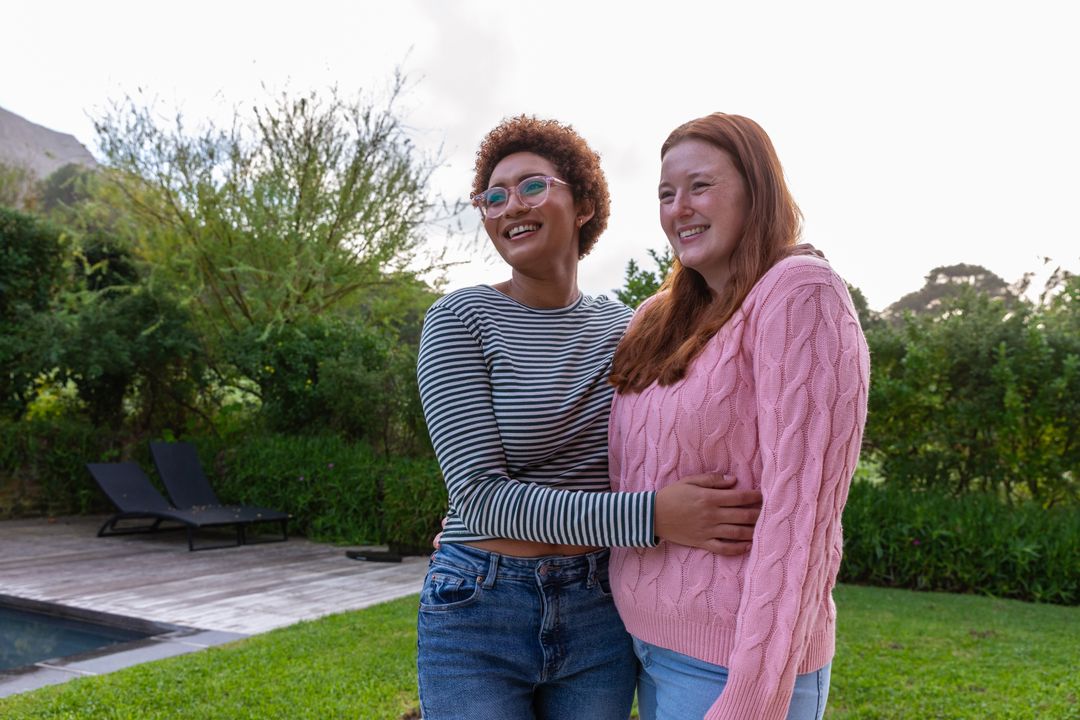 Diverse Female Friends Embracing in Backyard Setting