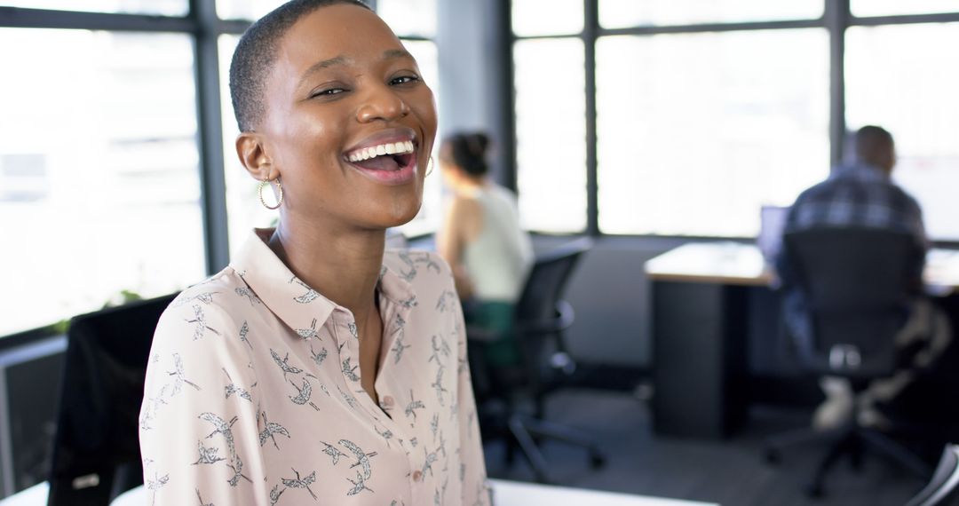 Joyful African American Businesswoman Smiling in Modern Office Environment - Free Images, Stock Photos and Pictures on Pikwizard.com