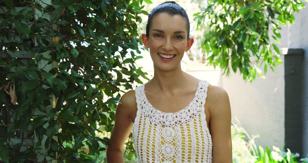 Smiling Woman Relaxing in Quirky Crochet Attire at Garden