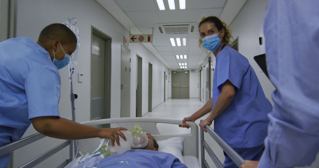 Medical Team Treating Patient in Hospital Corridor - Free Images, Stock Photos and Pictures on Pikwizard.com