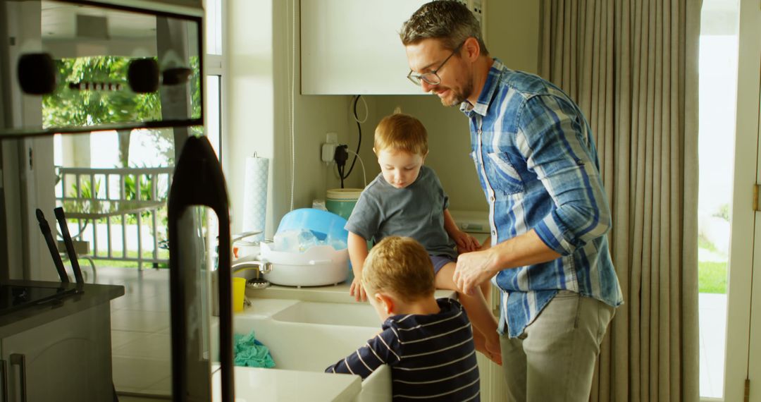 Father Washing Hands with Sons in Kitchen - Free Images, Stock Photos and Pictures on Pikwizard.com