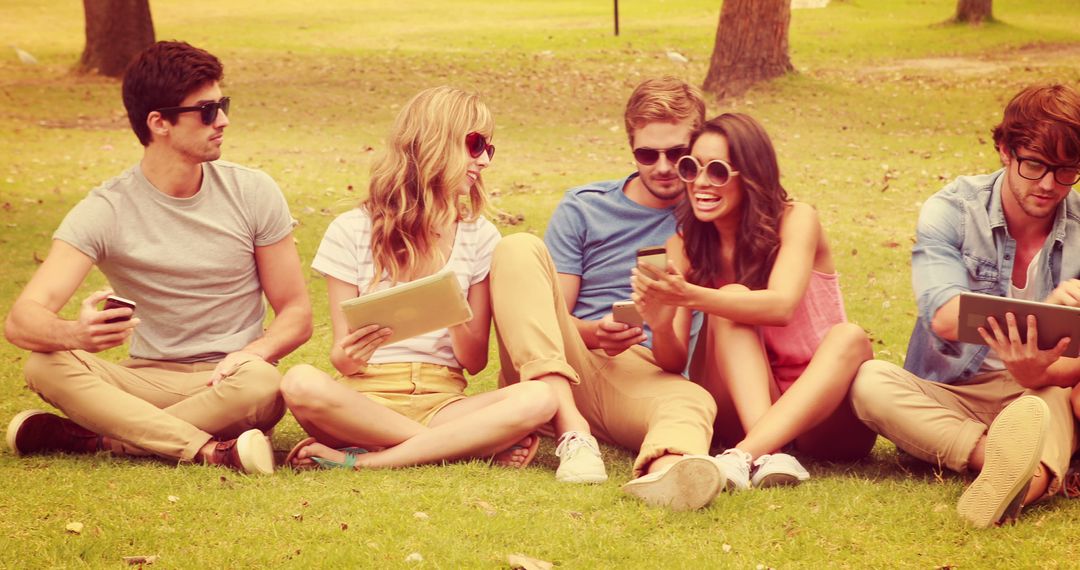 Group of Friends Relaxing on Grass with Technological Devices - Free Images, Stock Photos and Pictures on Pikwizard.com