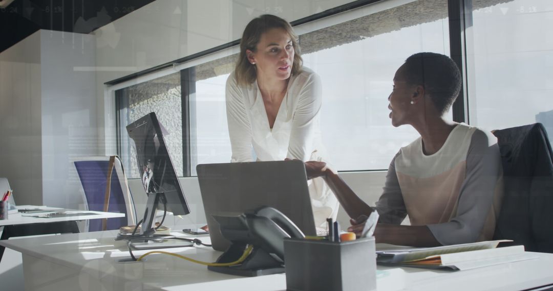 Multiracial Coworkers Collaborating on Project with Laptop and Data Analysis