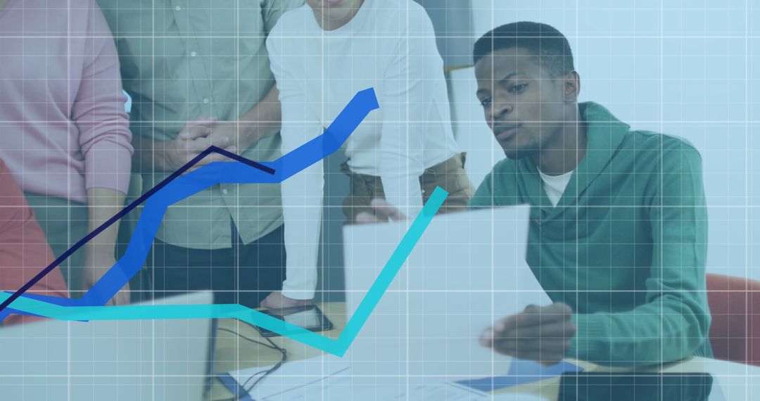 Diverse Team Analyzing Dynamic Financial Charts in Office Setting