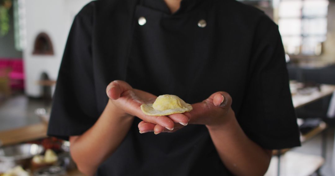 Skilled Chef Presenting Freshly Made Dumpling in Kitchen - Free Images, Stock Photos and Pictures on Pikwizard.com