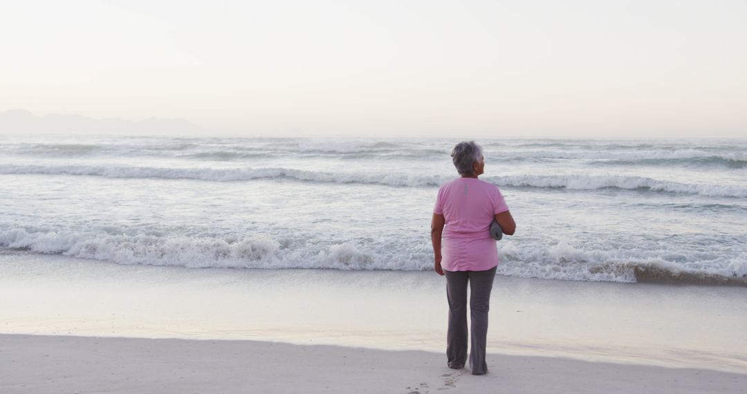 Senior Woman Enjoying Serene Beach View During Sunset - Free Images, Stock Photos and Pictures on Pikwizard.com