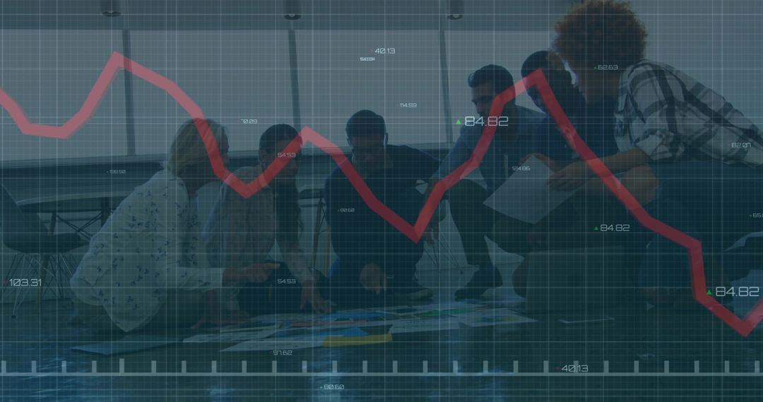 Business Team Analyzing Data with Projected Red Line Graph Overlay