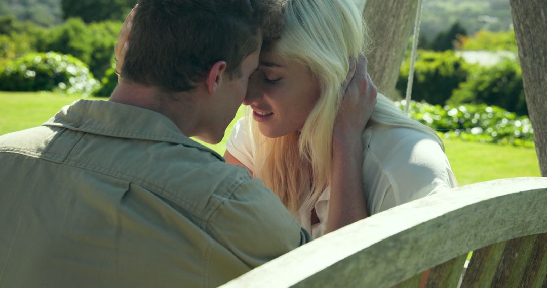 Couple Embracing on Wooden Swing in Serene Garden