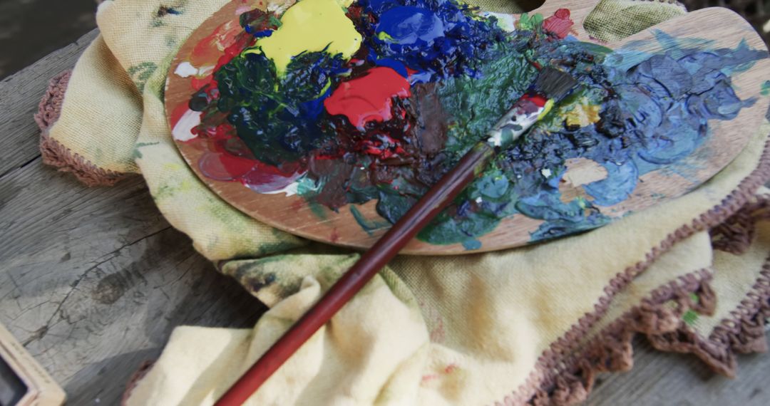 Close-Up View of Artist's Paint Palette and Brush on Cloth - Free Images, Stock Photos and Pictures on Pikwizard.com