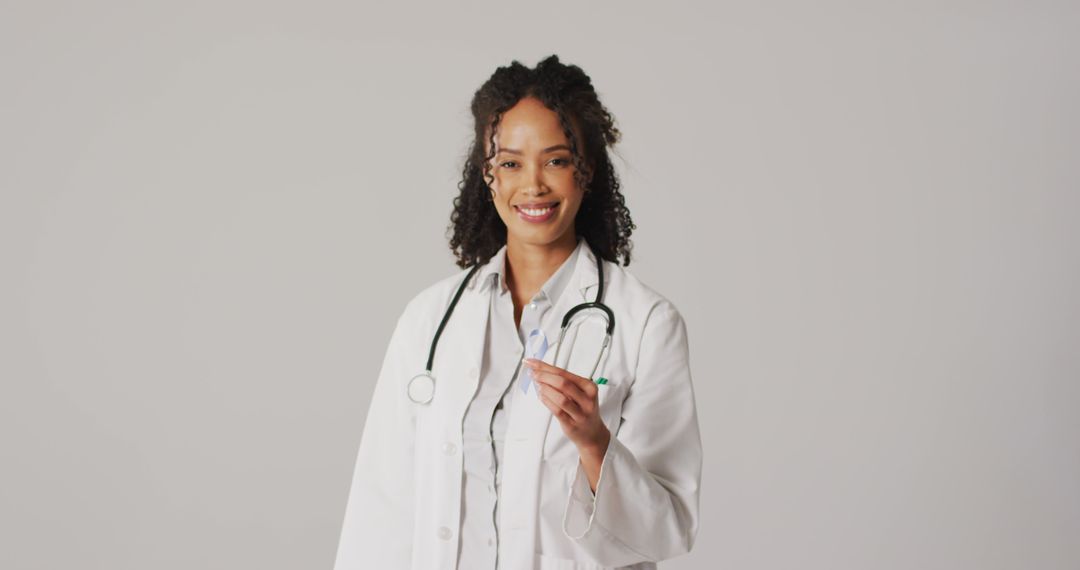 Smiling Female Doctor Holding Lung Cancer Awareness Ribbon - Free Images, Stock Photos and Pictures on Pikwizard.com