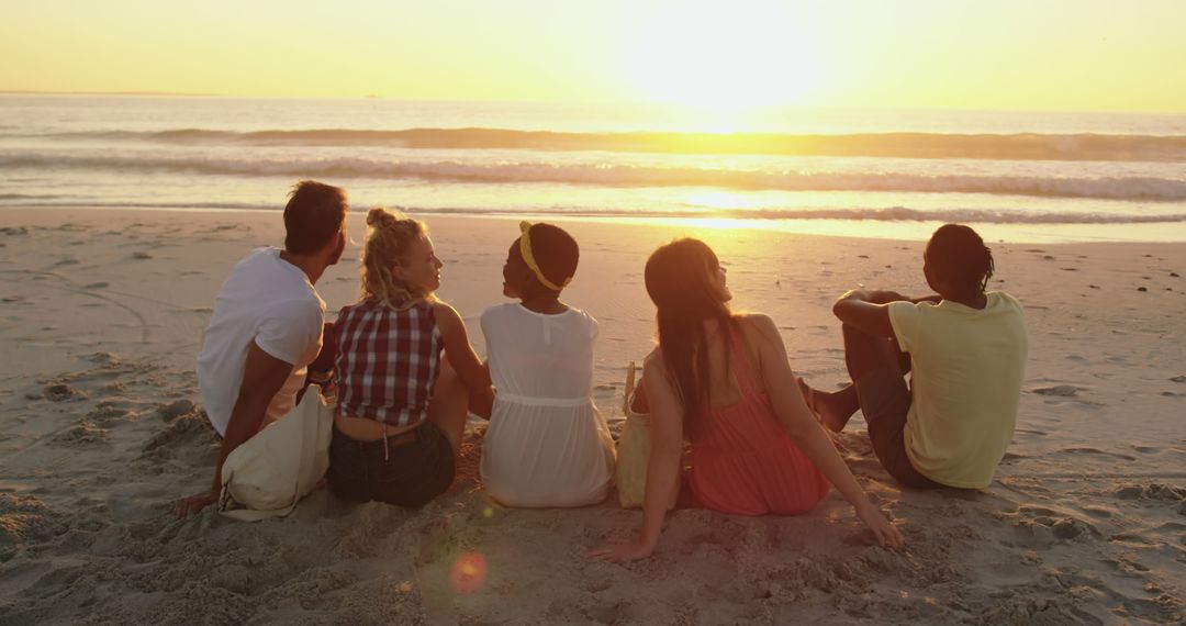 Group of Diverse Friends Watching Sunset on Beach - Free Images, Stock Photos and Pictures on Pikwizard.com