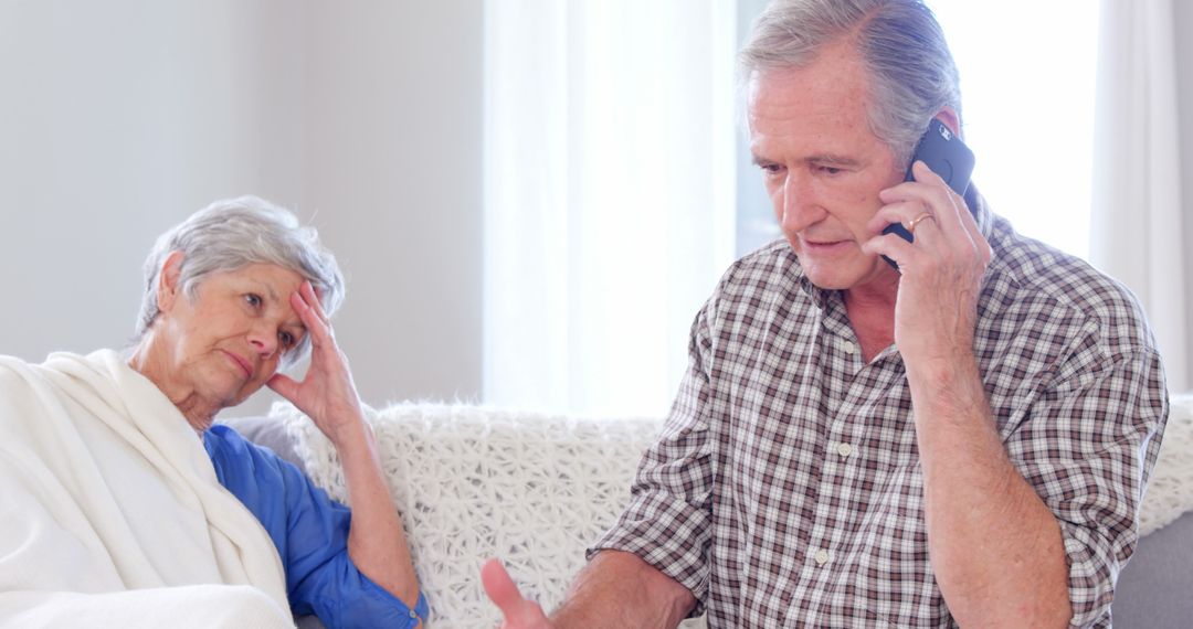 Concerned Elderly Man Talking on Smartphone with Worried Woman - Free Images, Stock Photos and Pictures on Pikwizard.com