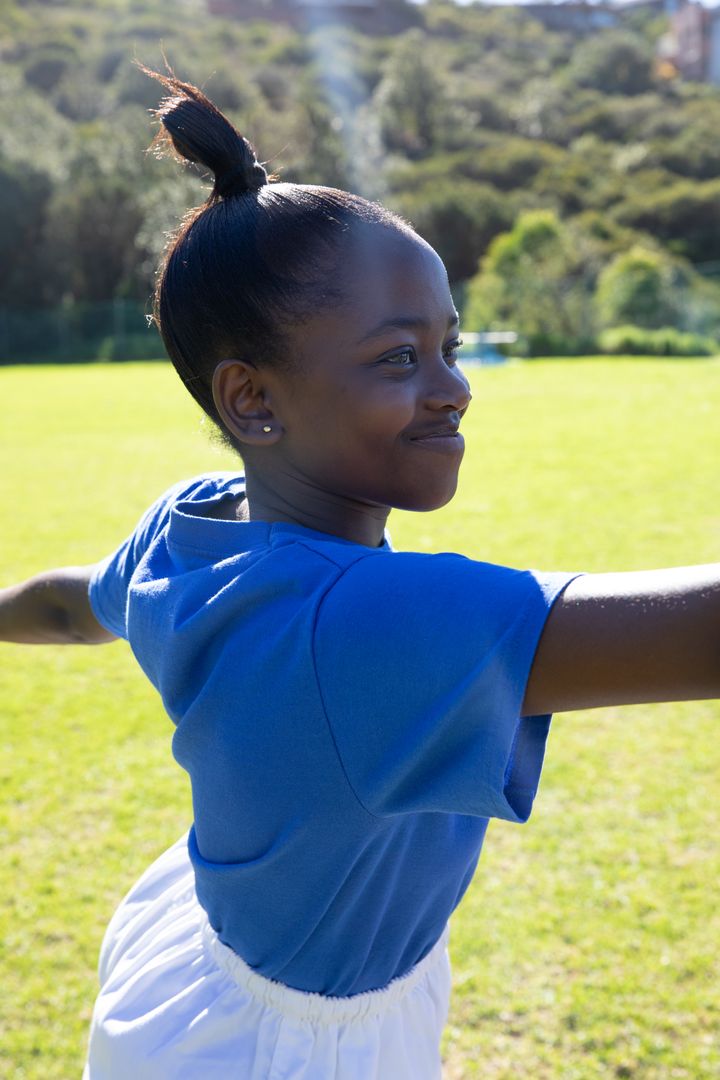 Joyful Child Balancing in Sunny Field Embracing Nature