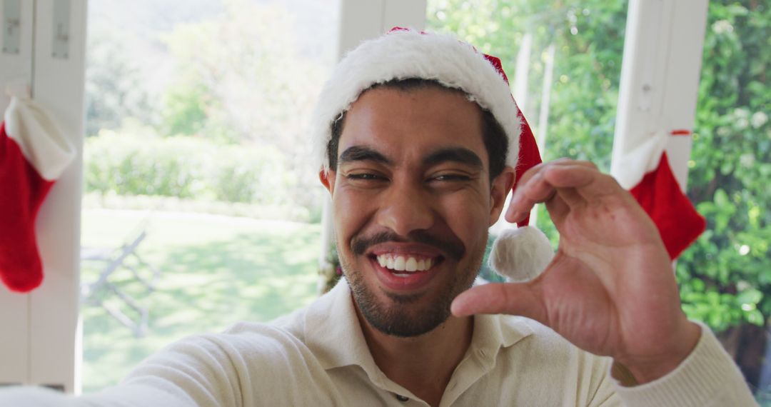 Smiling Young Man Taking Christmas Selfie at Home - Free Images, Stock Photos and Pictures on Pikwizard.com