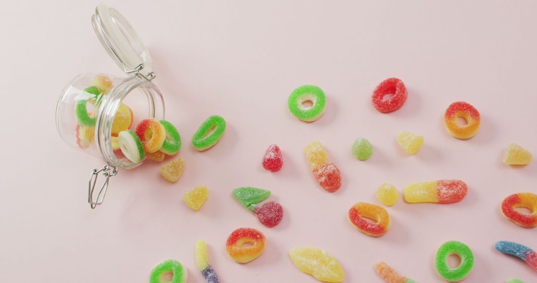 Colorful Assorted Gummy Candies Spilled from Jar on Pink Background - Free Images, Stock Photos and Pictures on Pikwizard.com