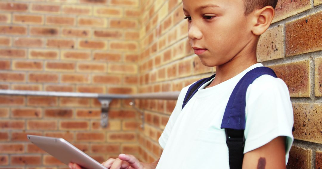 Young Boy Using Digital Tablet at School - Free Images, Stock Photos and Pictures on Pikwizard.com