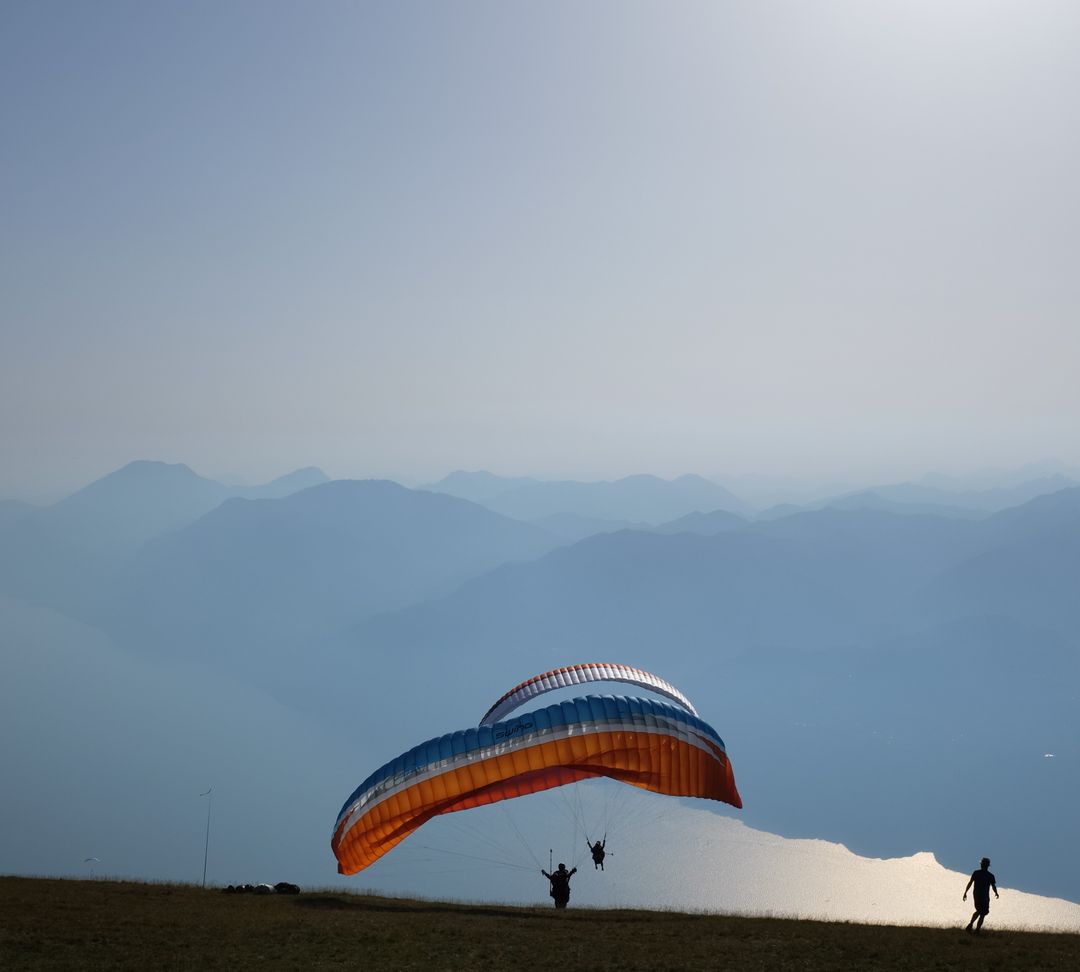 Paragliders Launching Off Mountain with Scenic Blue Horizon View - Free Images, Stock Photos and Pictures on Pikwizard.com