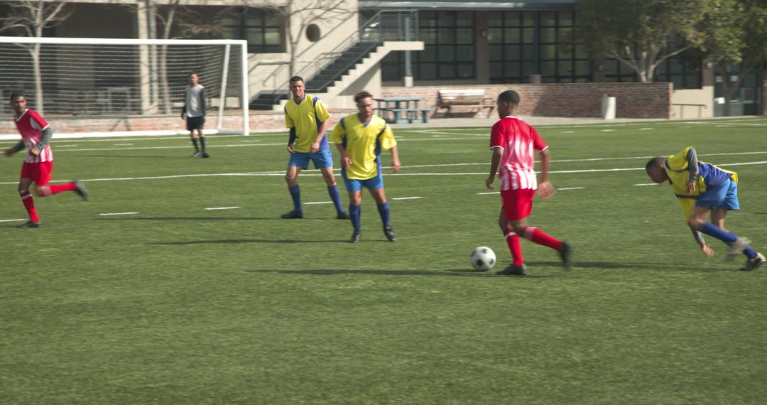 Young Soccer Players Competing on Sunlit Field