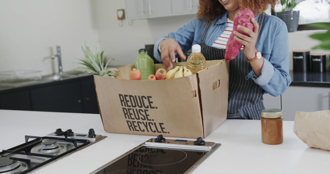 Woman Unpacking Groceries in Eco-friendly Box at Kitchen Counter - Free Images, Stock Photos and Pictures on Pikwizard.com