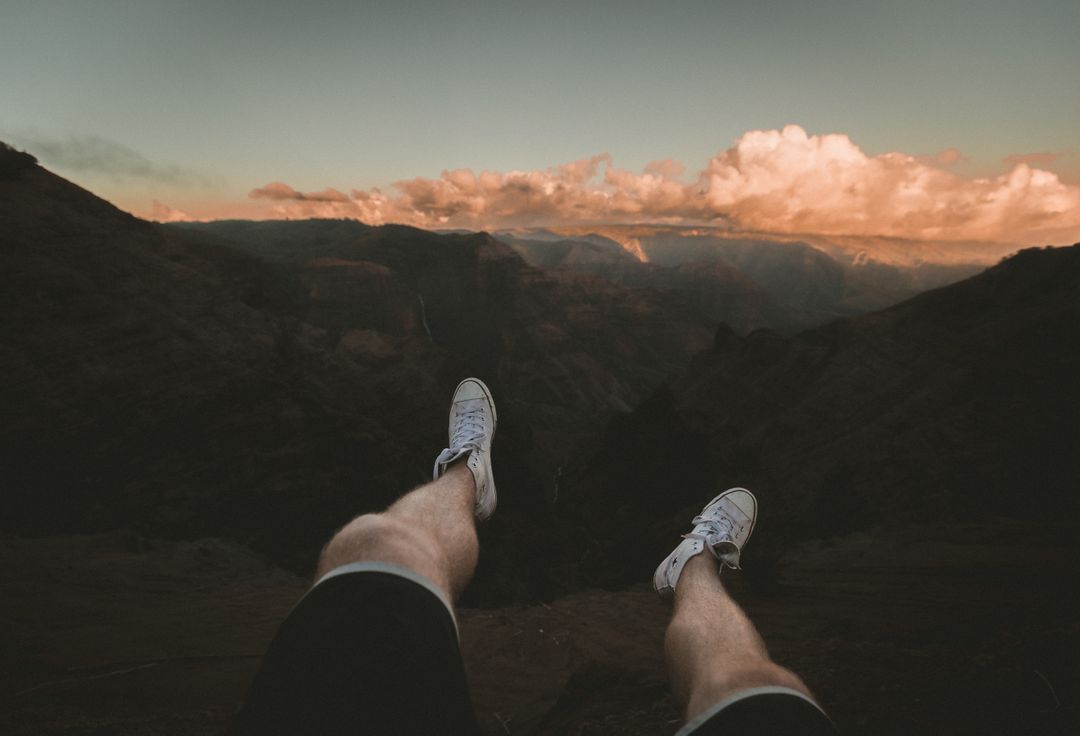 Dangling Feet Over Canyon at Sunset - Free Images, Stock Photos and Pictures on Pikwizard.com