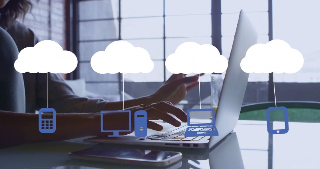 Man Using Laptop with Cloud Computing Icons Overlay