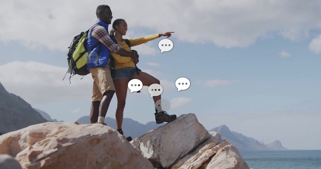 Couple Pointing Towards Ocean Horizon on Coastal Rock