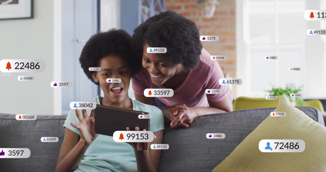 Mother and Daughter Engaging with Social Media Notifications on Tablet
