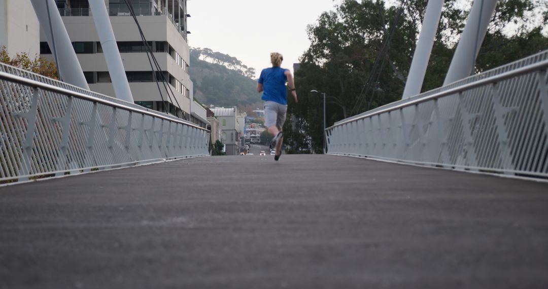 Person Running on Bridge in Urban Area During Morning - Free Images, Stock Photos and Pictures on Pikwizard.com