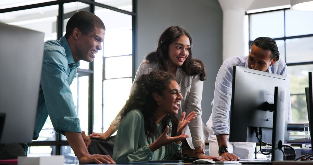 Diverse Team Celebrates Success in Modern Office