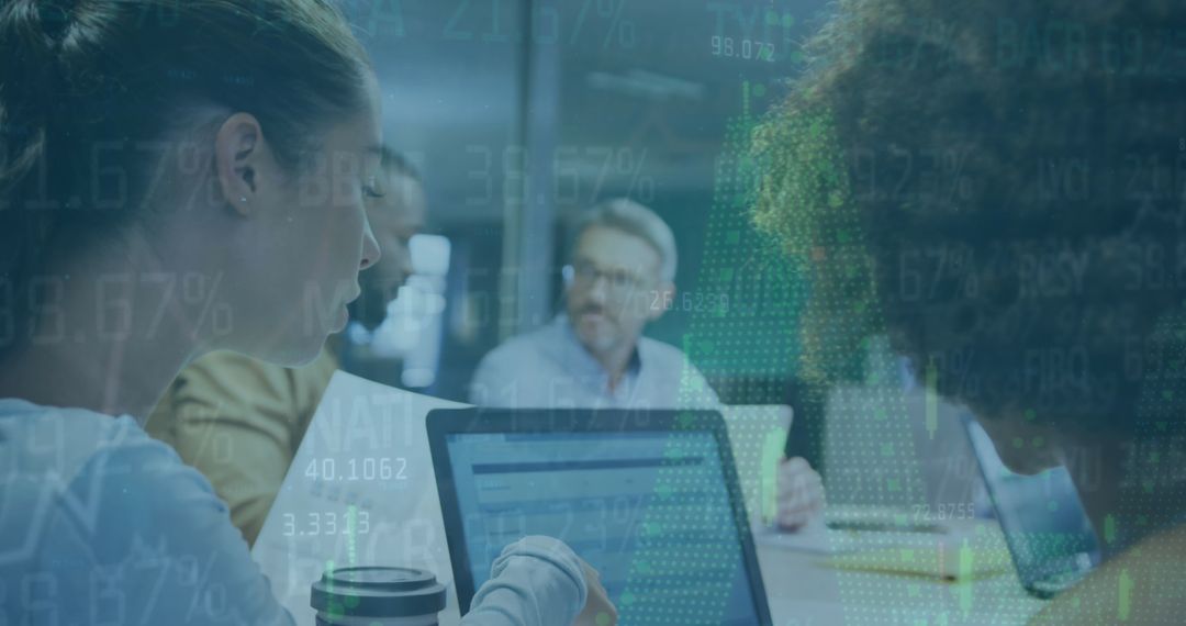 Diverse Team Analyzing Financial Data on Laptops in Modern Office