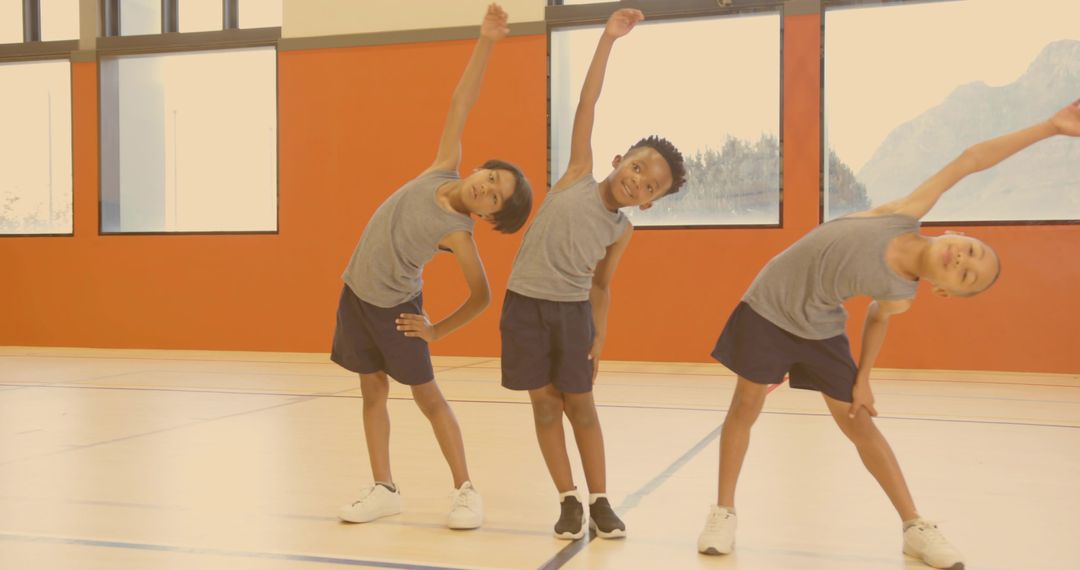 Boys Exercise with Side Bends in School Gym for Fitness and Teamwork