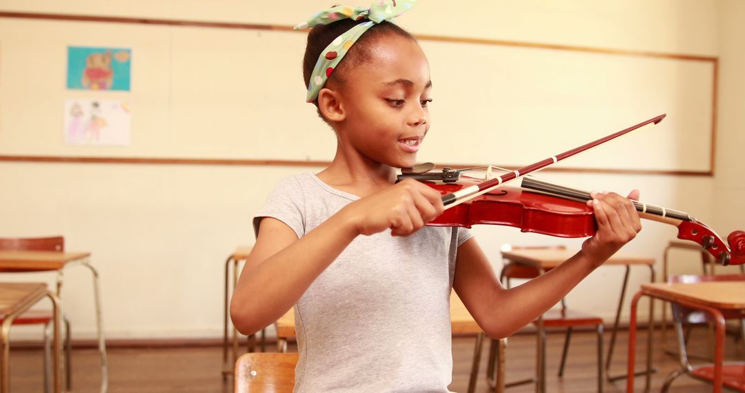 Young Student Joyfully Playing Violin in Classroom