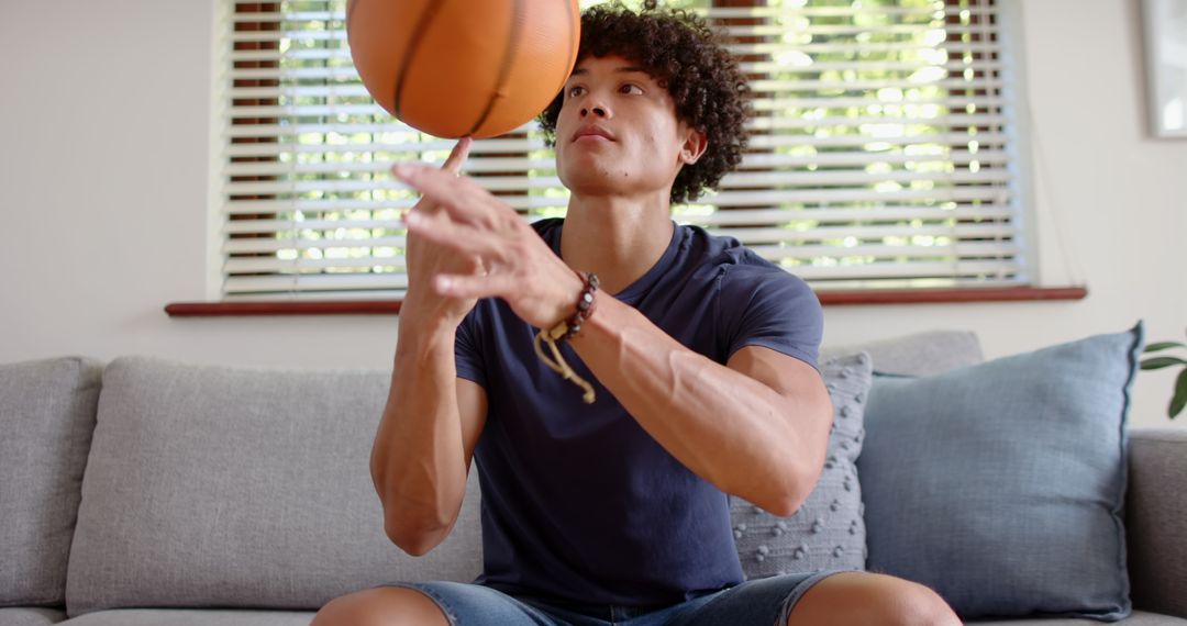 Young Man Spinning Basketball at Home in Relaxing Surroundings